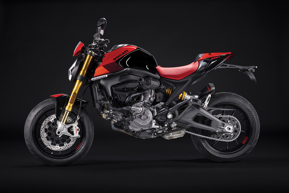 Full side view of red and black Ducati Monster bike